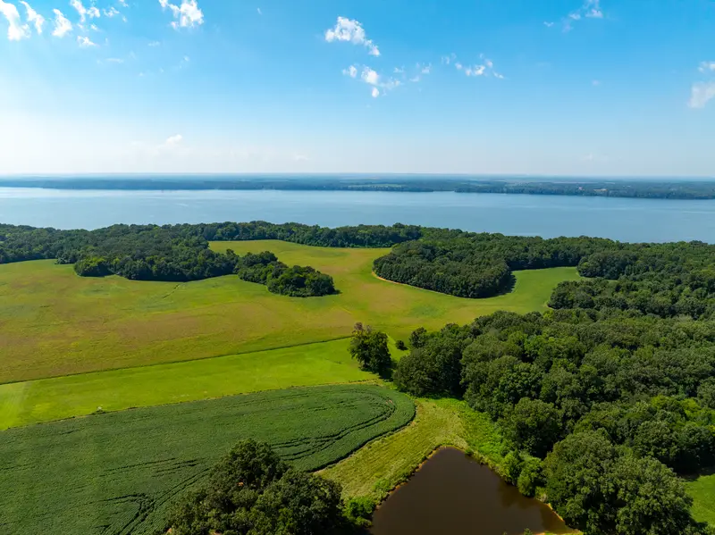 Farm pond among open fields